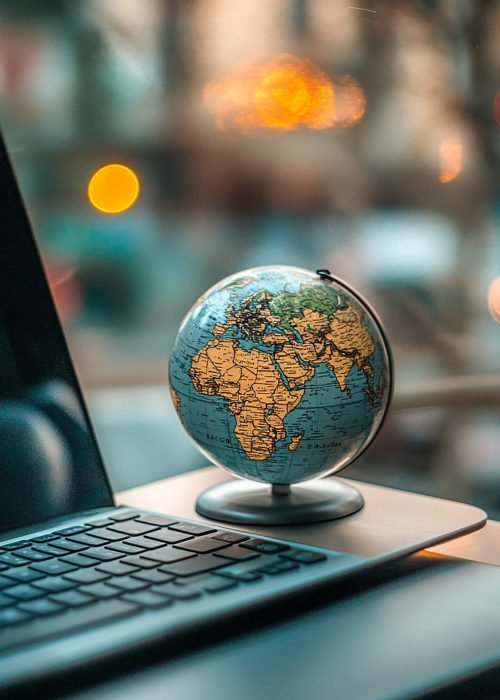 globe-sits-desk-with-laptop-background